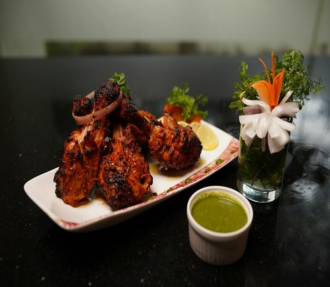 Tandoori chicken grilled in a traditional clay oven at TandoorTales